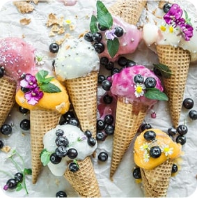 Ice-cream cones decorated with blueberries and flowers